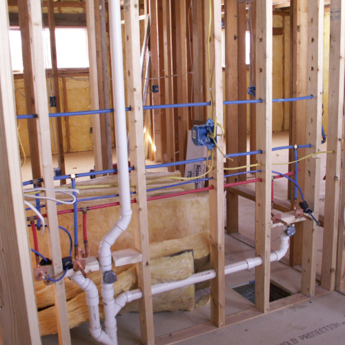 A room with a lot of pipes and wires in it