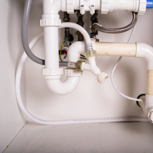 A white pipe with a blue hose attached to it