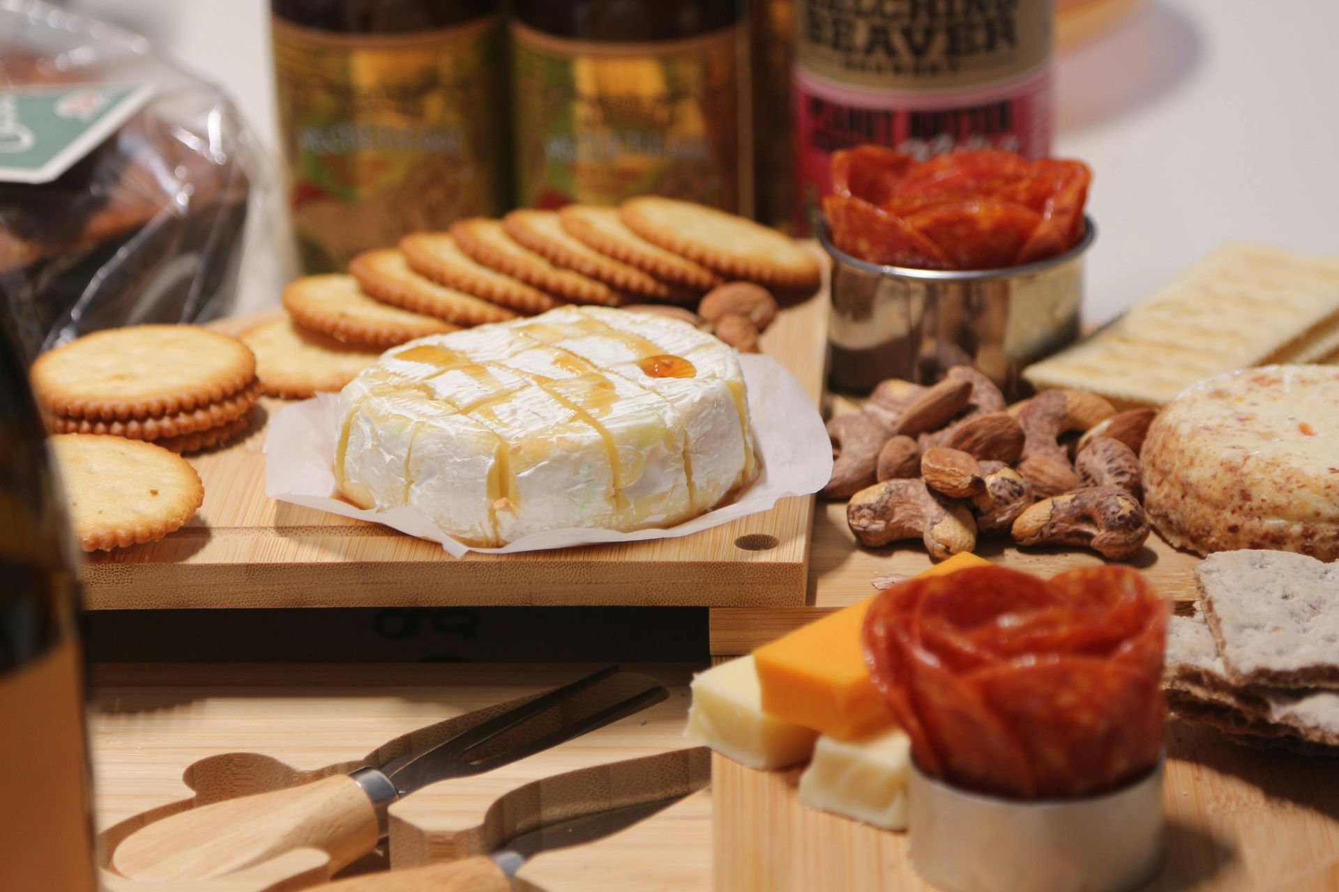 Assorted cheeses, crackers, nuts, and chutney arranged on a wooden serving board.