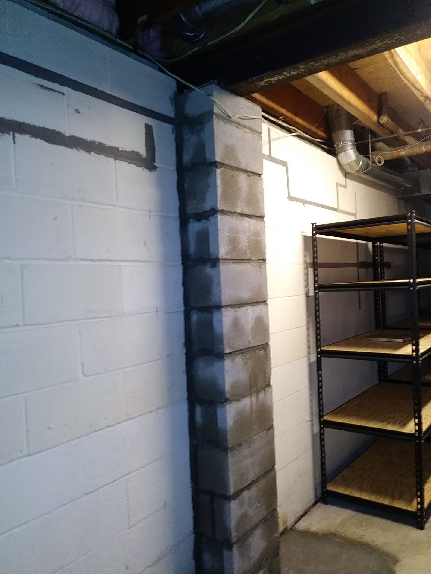 A room with a brick wall and shelves in it