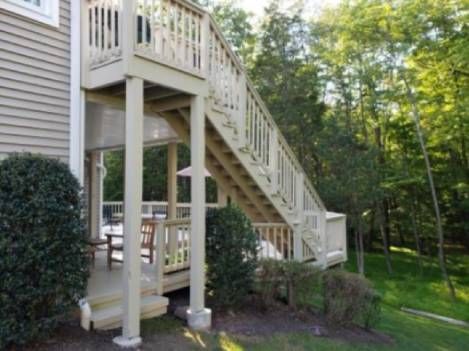 A house with a deck and stairs leading up to it