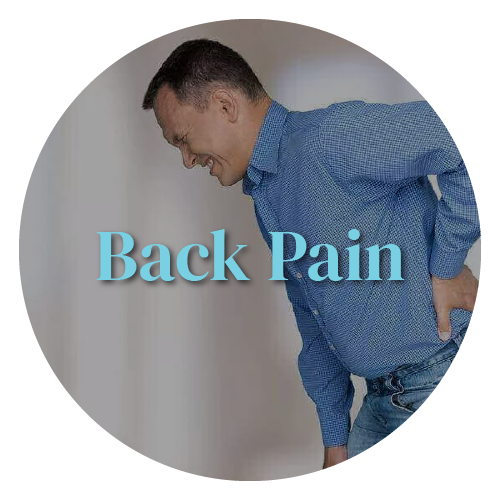 A man in a blue shirt is holding his back in pain.