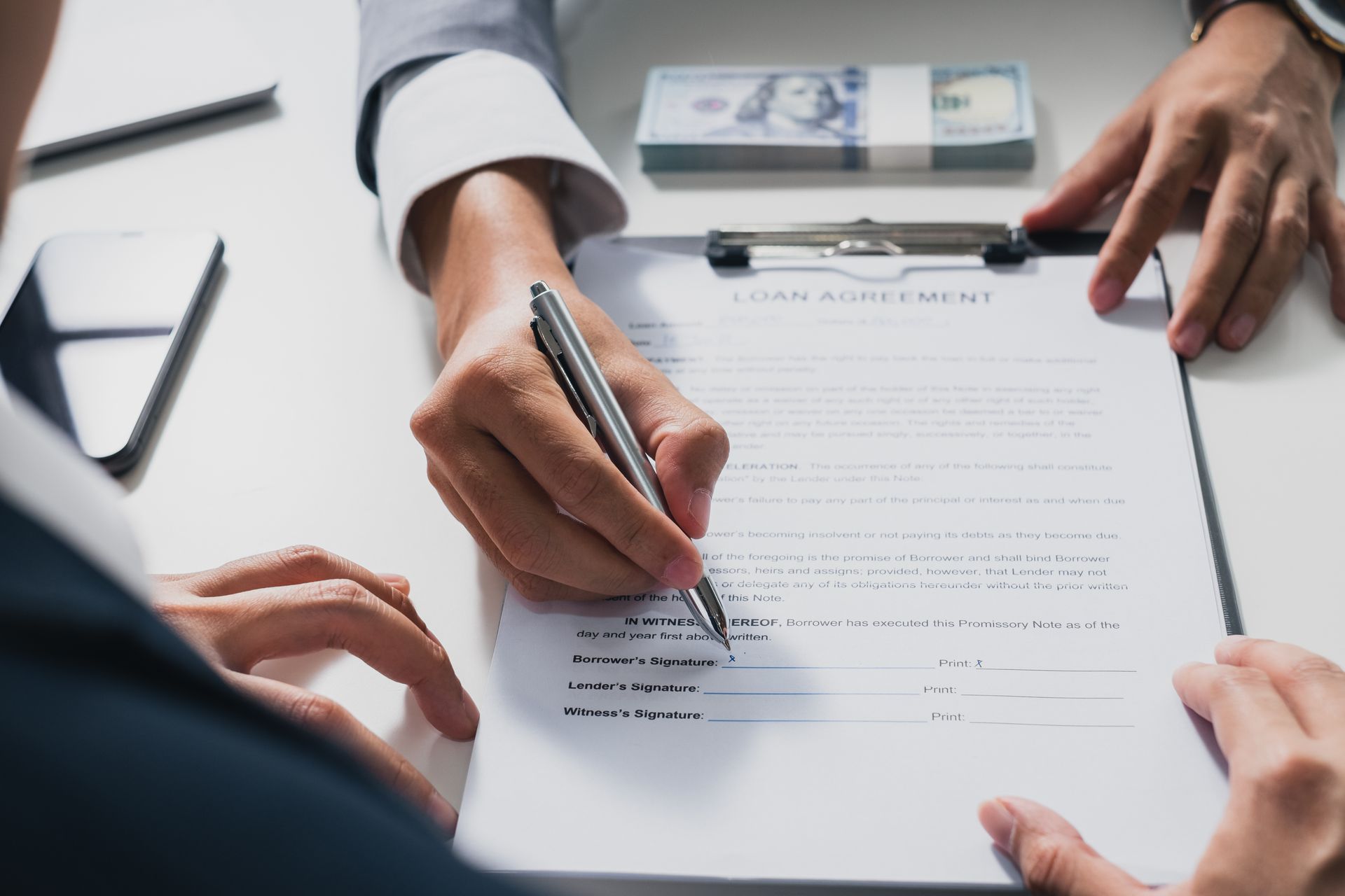 Businessman sign on money loan agreement contract. Businessman sign on money loan agreement contract.