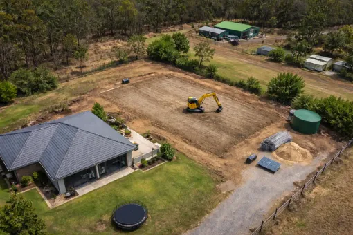 Aerial shot of an excavator preparing a large shed pad in Meringandan, Toowoomba