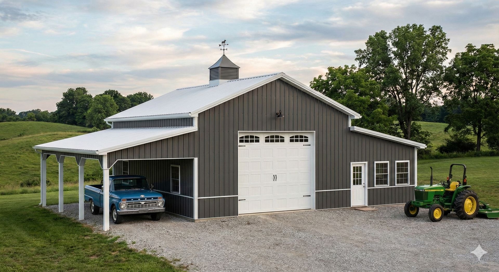 Gray barn with carport, white roof, and garage door; a classic blue car and green tractor are present.