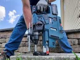 A group of tools are sitting on a wooden floor.
