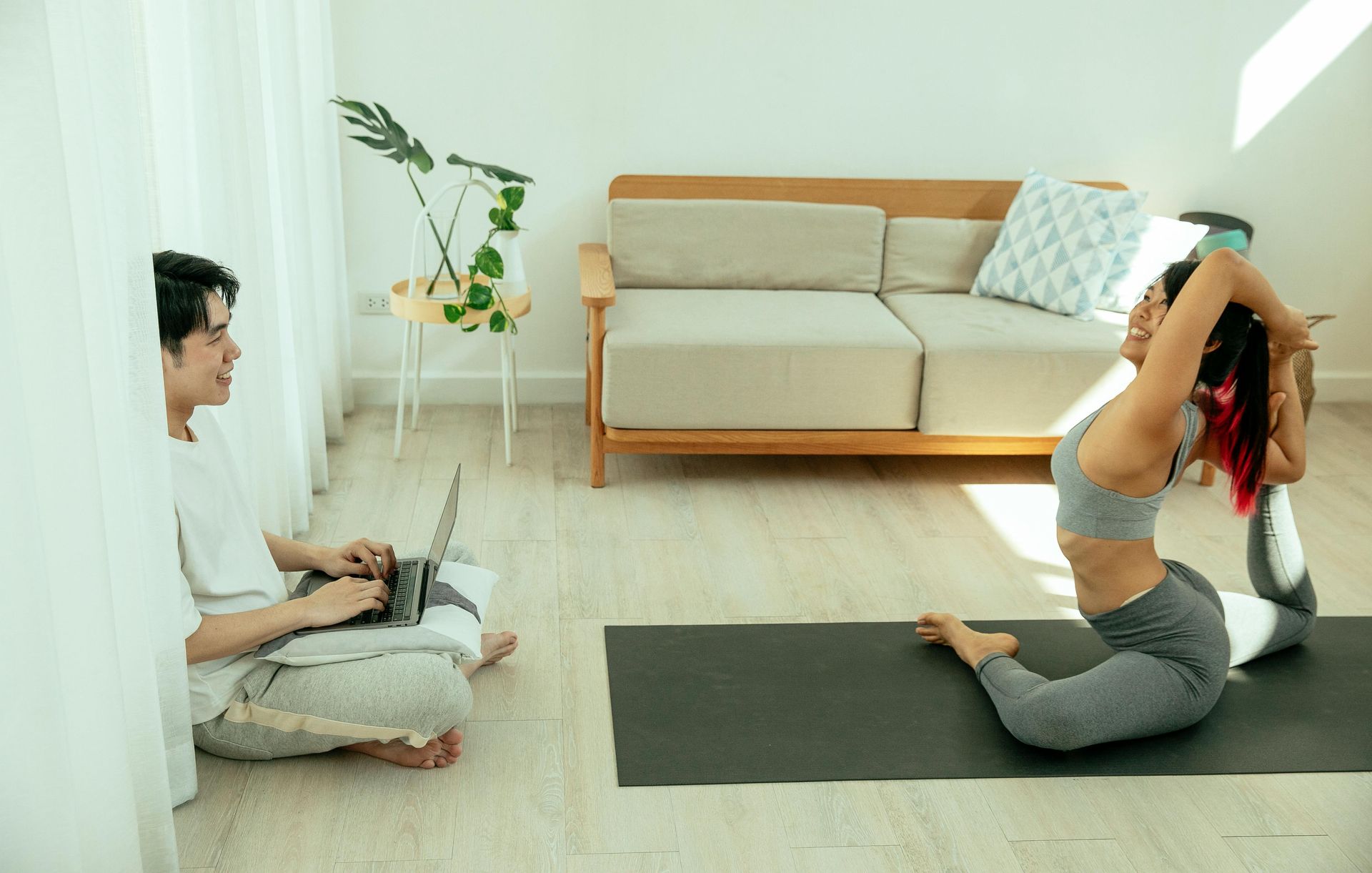 Side view of client practicing upright posture alignment using wall reference.