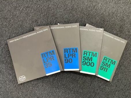 Five RTM audio tape boxes on a dark surface. Labels read: LPR35, LPR90, SM900, SM911. Gray boxes with blue and green accents.