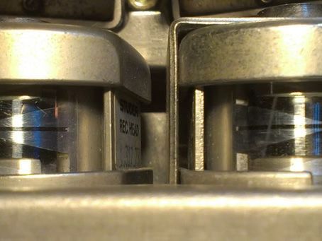 Close-up of a vintage reel-to-reel tape recorder's recording head and reels.
