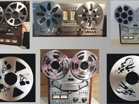 Several reel-to-reel tape recorders with silver metal spools, arranged in a grid.