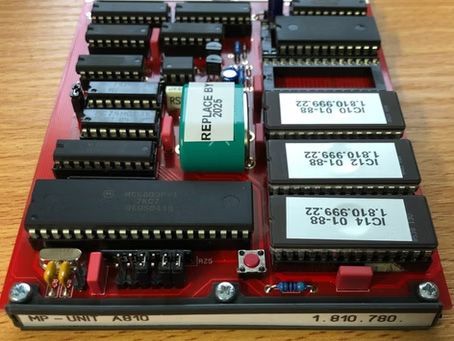 Red circuit board with chips and components labeled 
