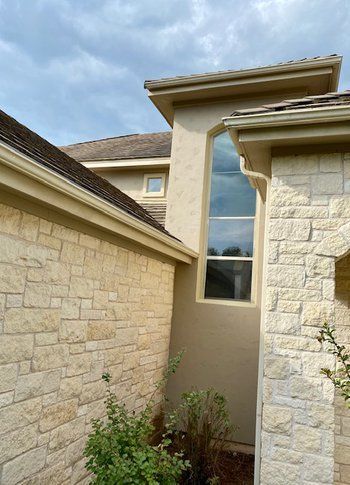 A house with a large window on the side of it.