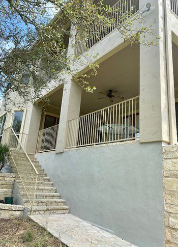 There are stairs leading up to the porch of a house.