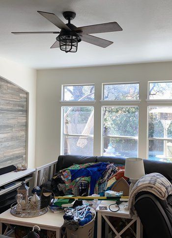 A living room filled with furniture and a ceiling fan.