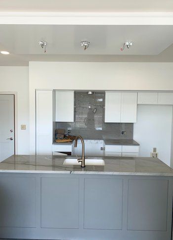 A kitchen with a large island and a sink