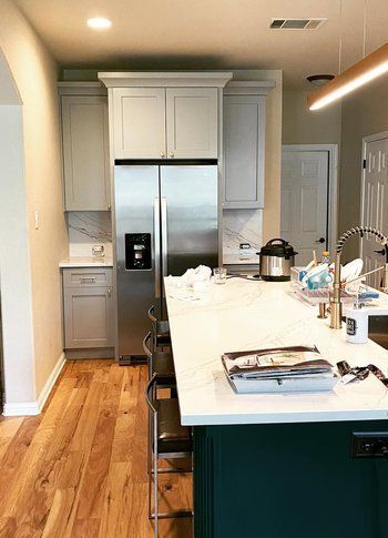 Home in Circle C neighborhood in southwest Austin, TX that had kitchen remodel including new cabinets, cabinet painting, new countertops, and new backsplash completed by Austin Painting and Cabinets