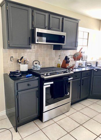 Home in Austin, TX that had kitchen remodel including cabinet painting, new countertops, and new backsplash completed by Austin Painting and Cabinets