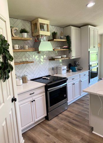 Home in Lake Travis area of Austin, TX that had kitchen remodel including cabinet painting and new countertops completed by Austin Painting and Cabinets