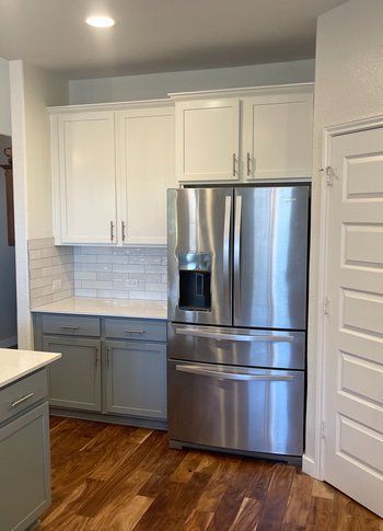 Home in Austin, TX that had kitchen remodel including cabinet painting, new countertops, and new backsplash completed by Austin Painting and Cabinets