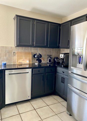 Home in Austin, TX that had kitchen remodel including cabinet painting, new countertops, and new backsplash completed by Austin Painting and Cabinets