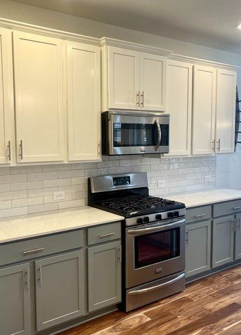 Home in Austin, TX that had kitchen remodel including cabinet painting, new countertops, and new backsplash completed by Austin Painting and Cabinets