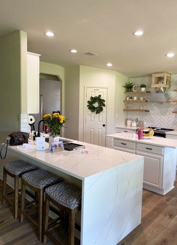 Home in Lake Travis area of Austin, TX that had kitchen remodel including cabinet painting and new countertops completed by Austin Painting and Cabinets