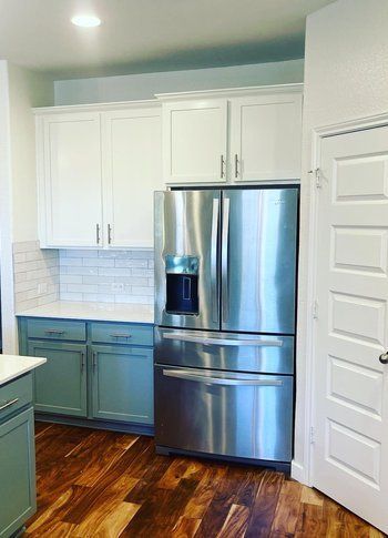 Home in Austin, TX that had kitchen remodel including cabinet painting, new countertops, and new backsplash completed by Austin Painting and Cabinets