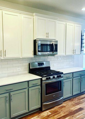 Home in Austin, TX that had kitchen remodel including cabinet painting, new countertops, and new backsplash completed by Austin Painting and Cabinets