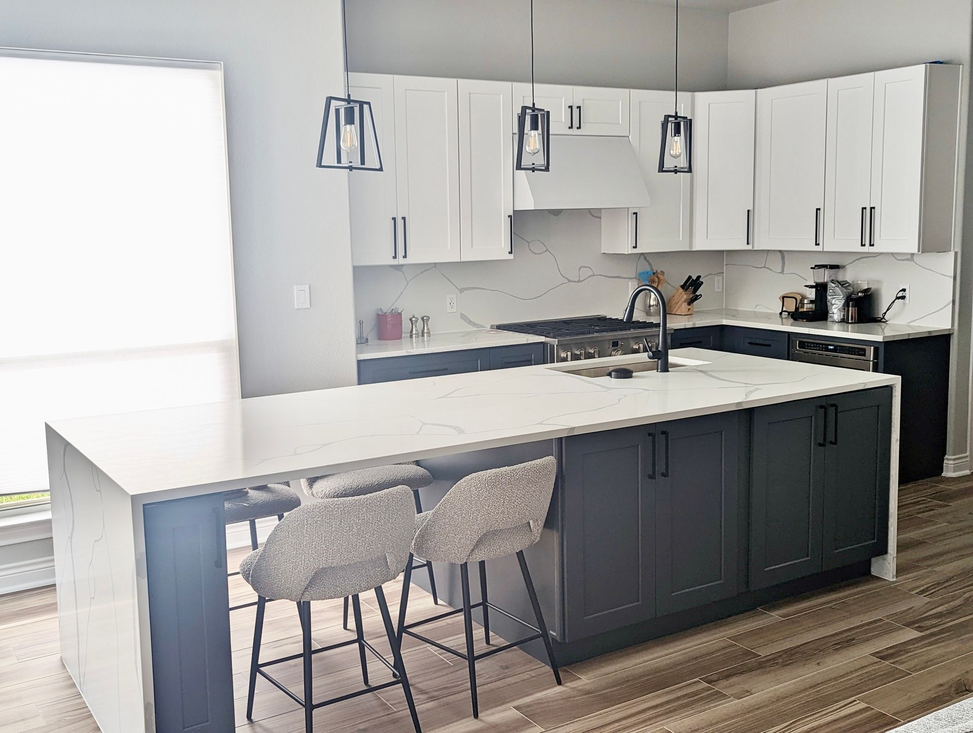 Circle C Ranch Austin kitchen remodel with white shaker cabinets Gravel Gray lower cabinets MSI Calacatta Classique quartz and waterfall island
