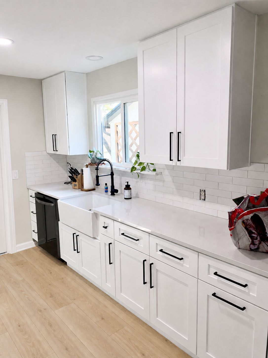 Austin kitchen remodel with white shaker cabinets quartz countertops and farmhouse sink