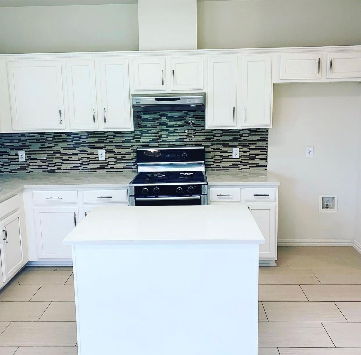 Austin kitchen remodel with painted cabinets quartz countertops and tile backsplash