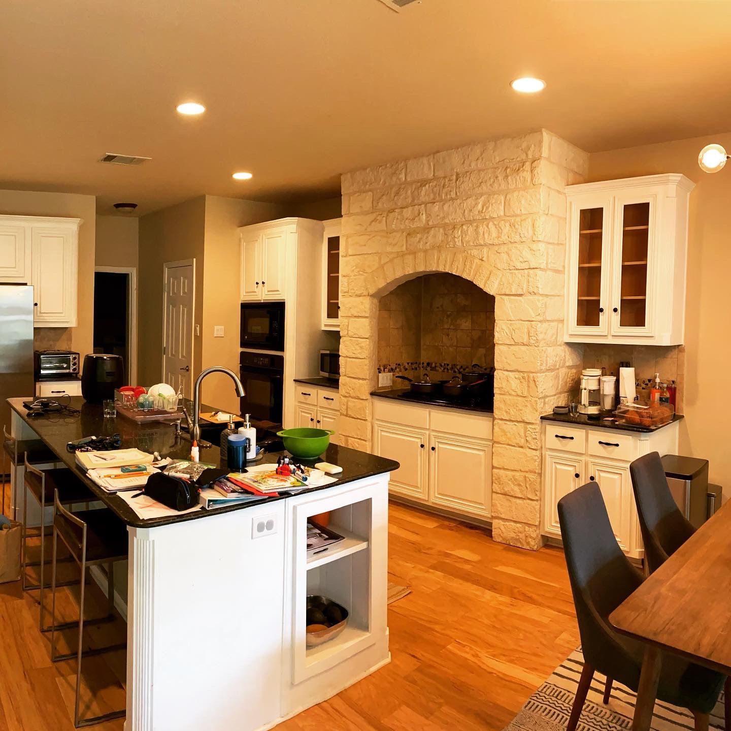 Austin kitchen before remodel with large stone range surround and oven tower in Circle C