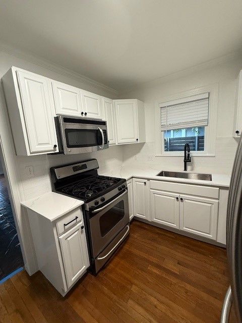 After kitchen remodel in downtown Austin with painted cabinets, quartz countertops, and tile backsplash