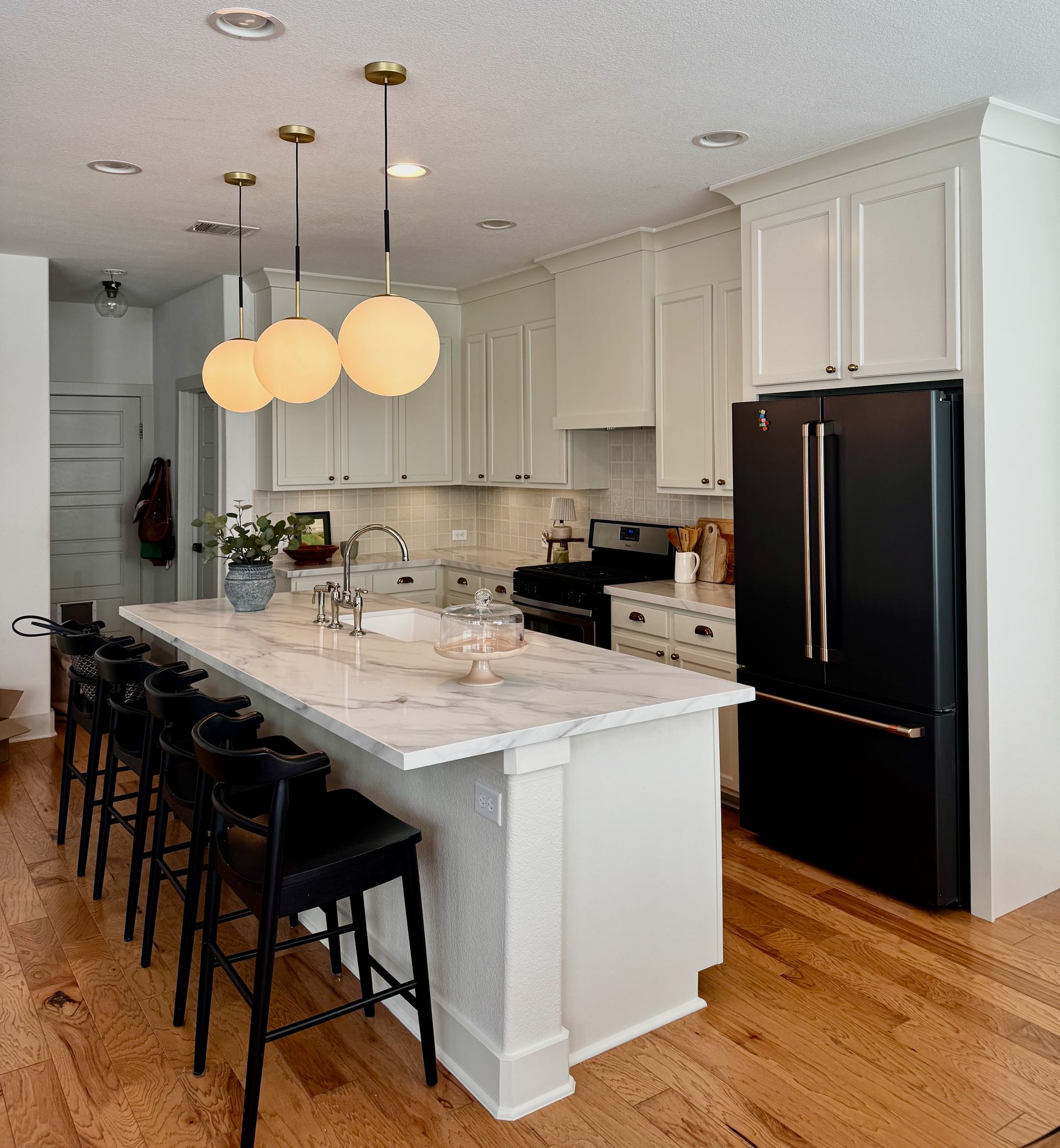 East Riverside Austin kitchen remodel with cabinets to ceiling custom hood quartz countertops