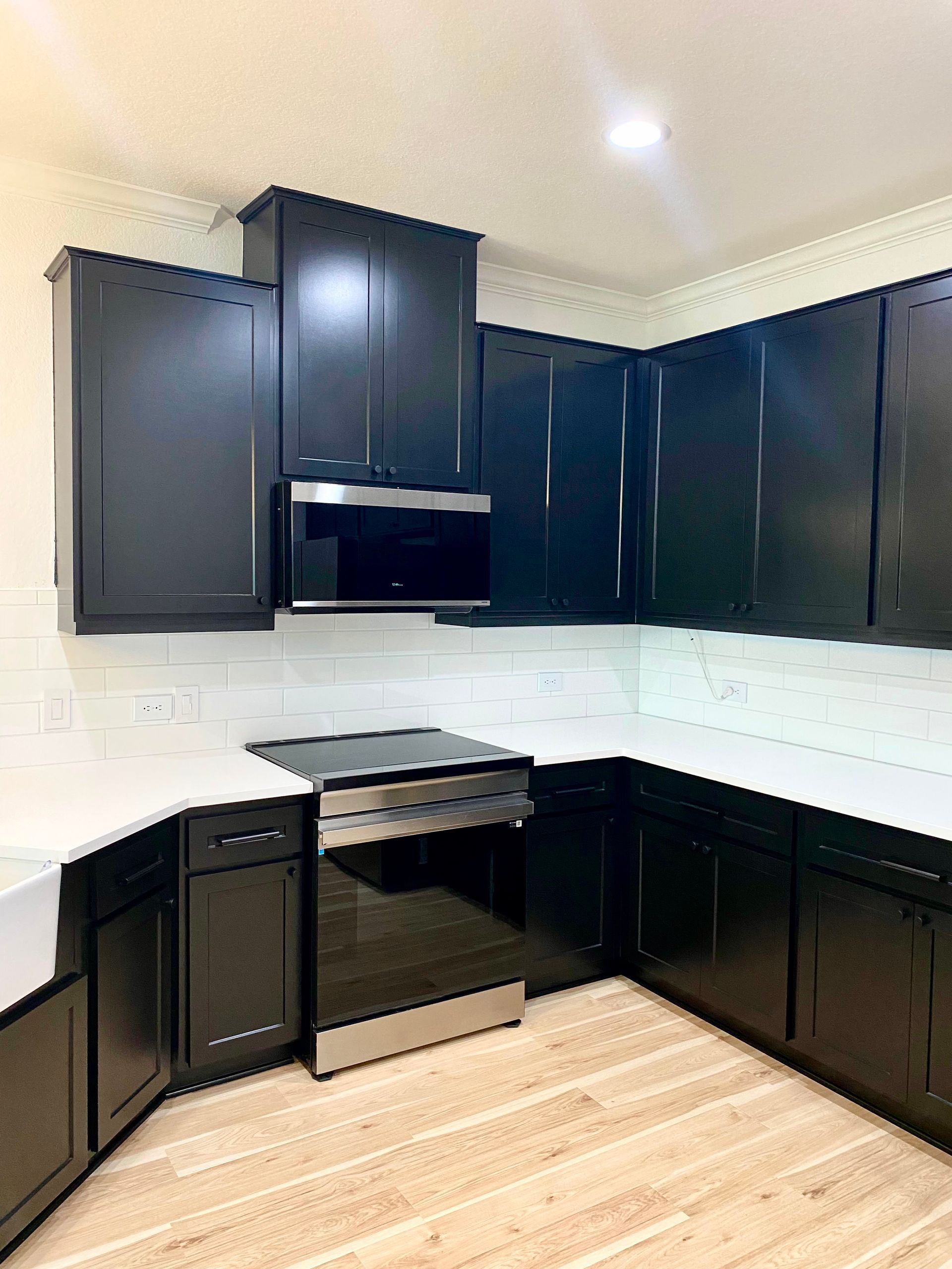 Georgetown kitchen after cabinet refacing with soft-close hardware new cabinet pulls and retained countertops
