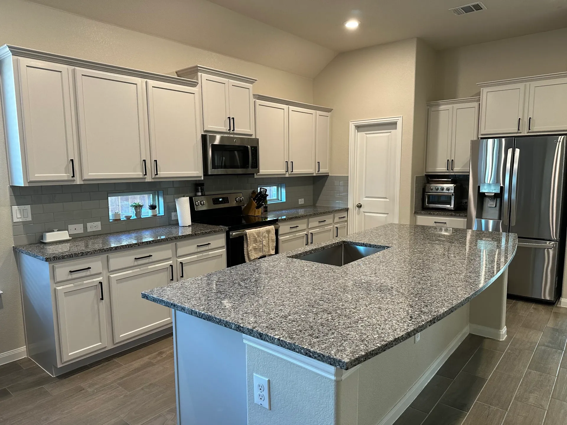 Cabinet painting project in Georgetown completed before the homeowner returned for new laundry room cabinets