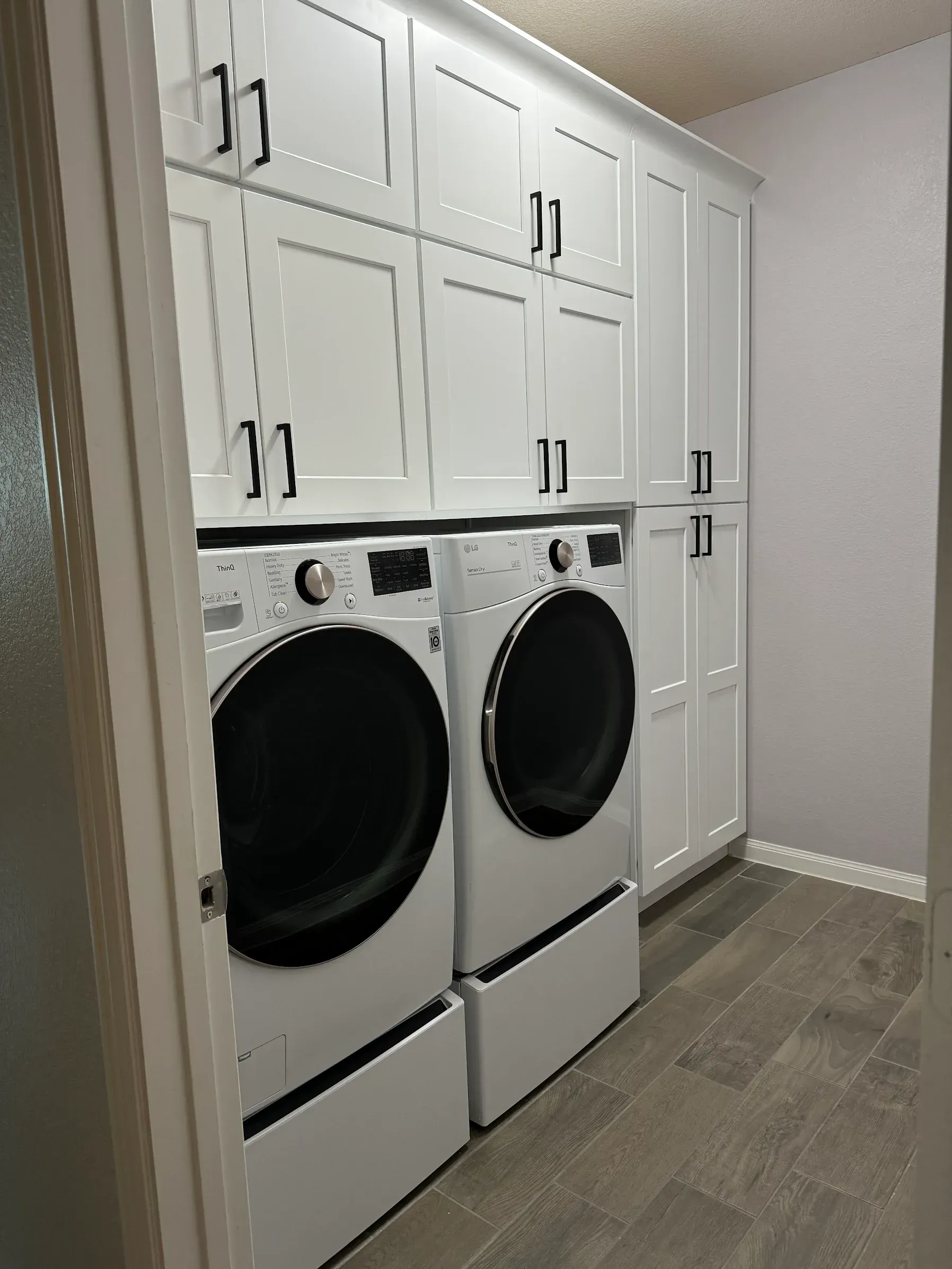 New shaker cabinets installed in a Georgetown laundry room for a repeat client of Austin Painting and Cabinets