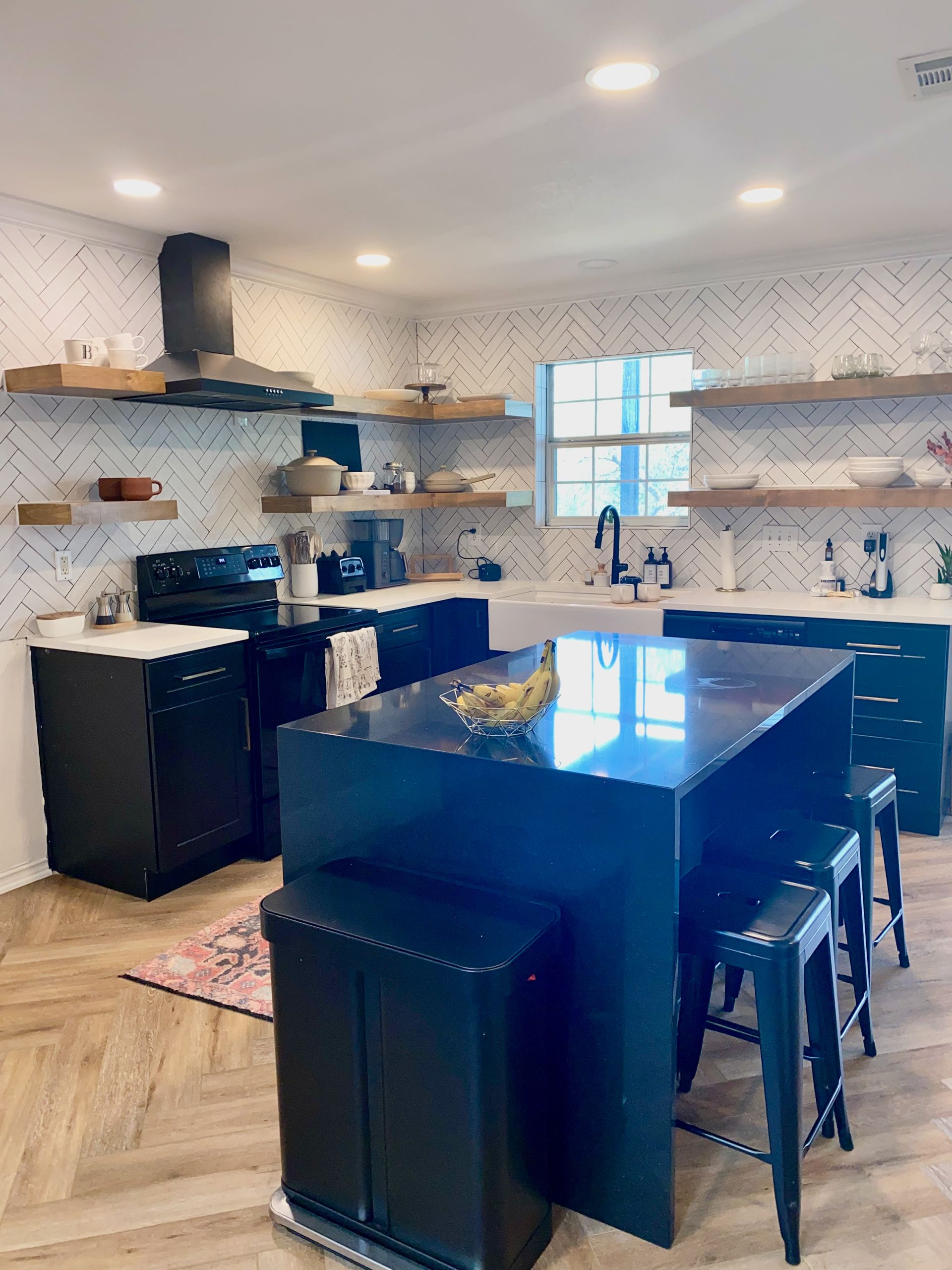 After photo of Lago Vista kitchen remodel with new cabinets quartz countertops waterfall island