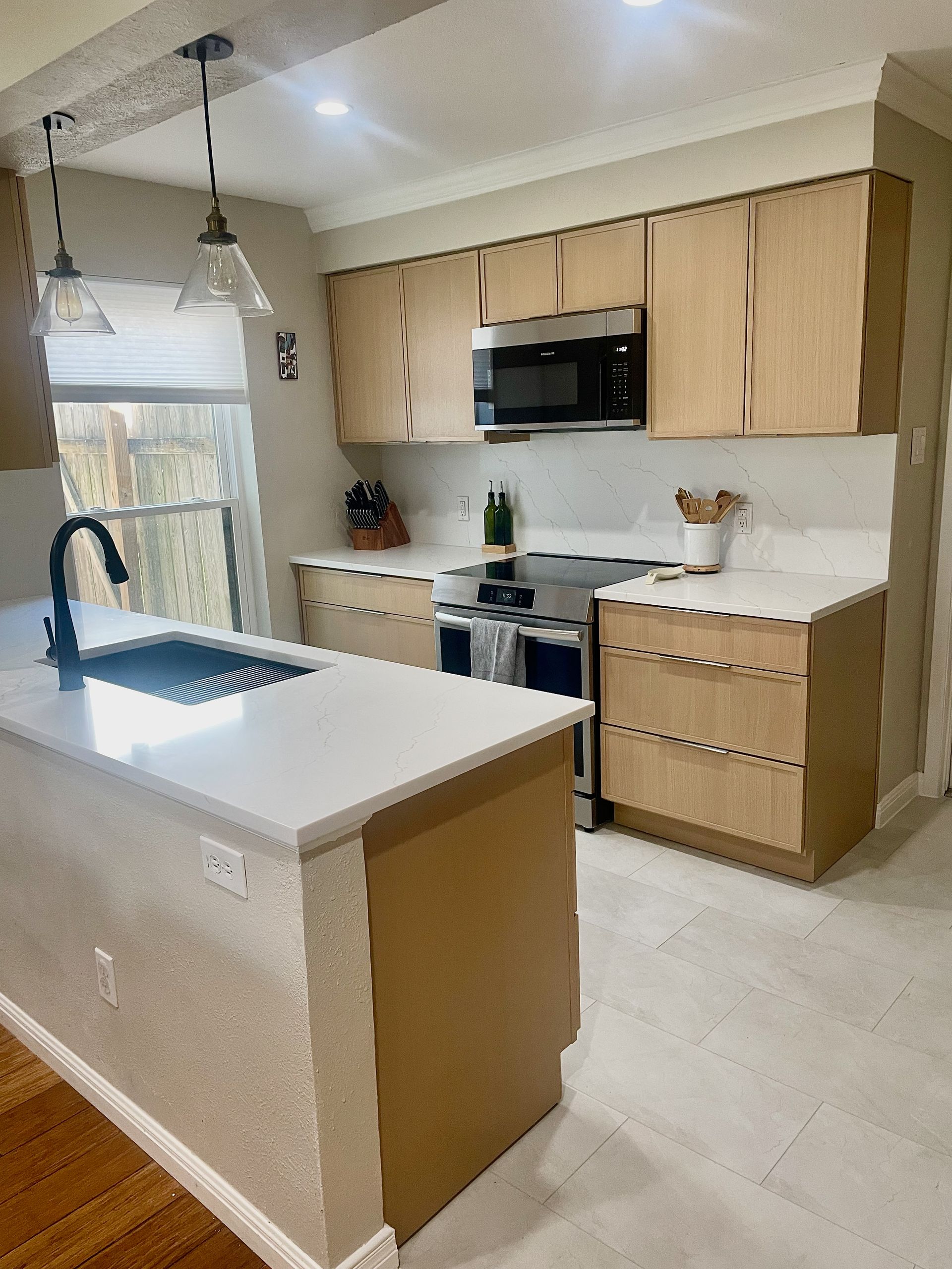 North Austin kitchen remodel near The Domain with white oak cabinets and quartz countertops
