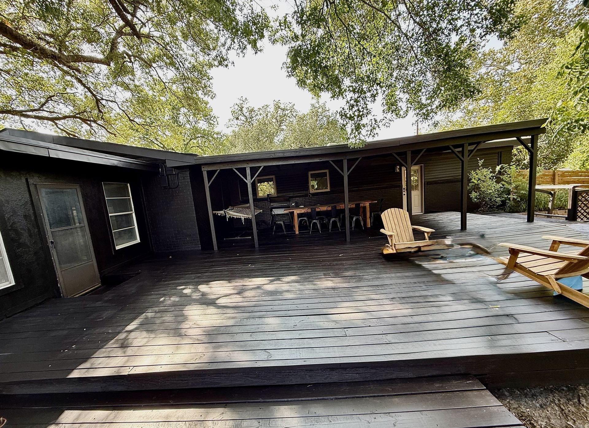 North Austin exterior painting project with Sherwin-Williams Caviar on brick siding doors patio and deck