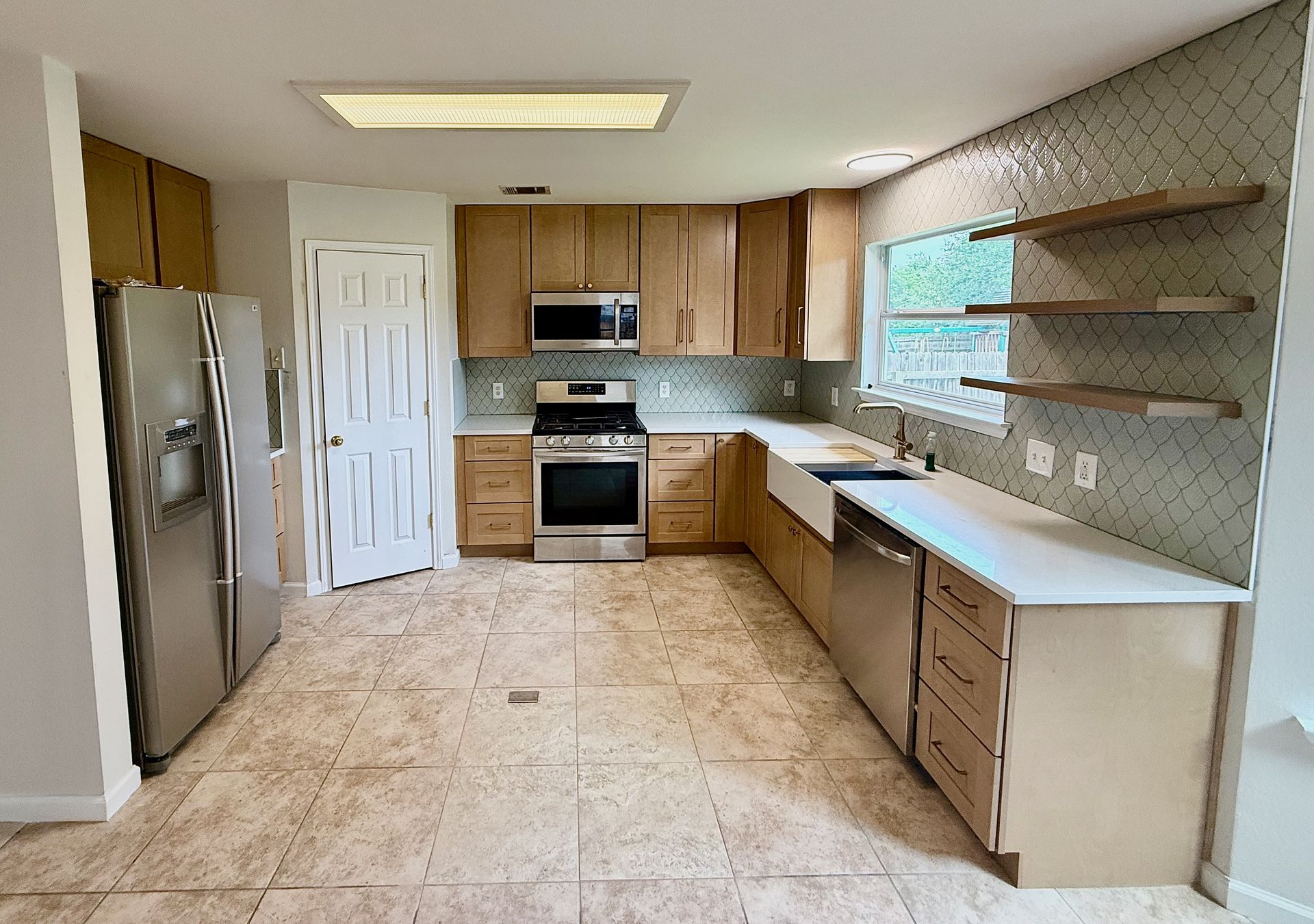 Northwest Austin kitchen remodel in Avery Ranch with new Timber shaker cabinets and Siberian Frost quartz countertops