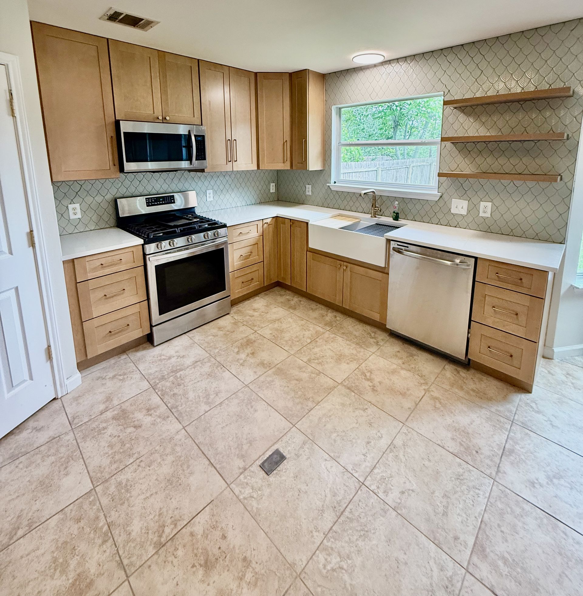 Avery Ranch kitchen remodel with farmhouse sink floating shelves and Soft Sage scallop tile backsplash