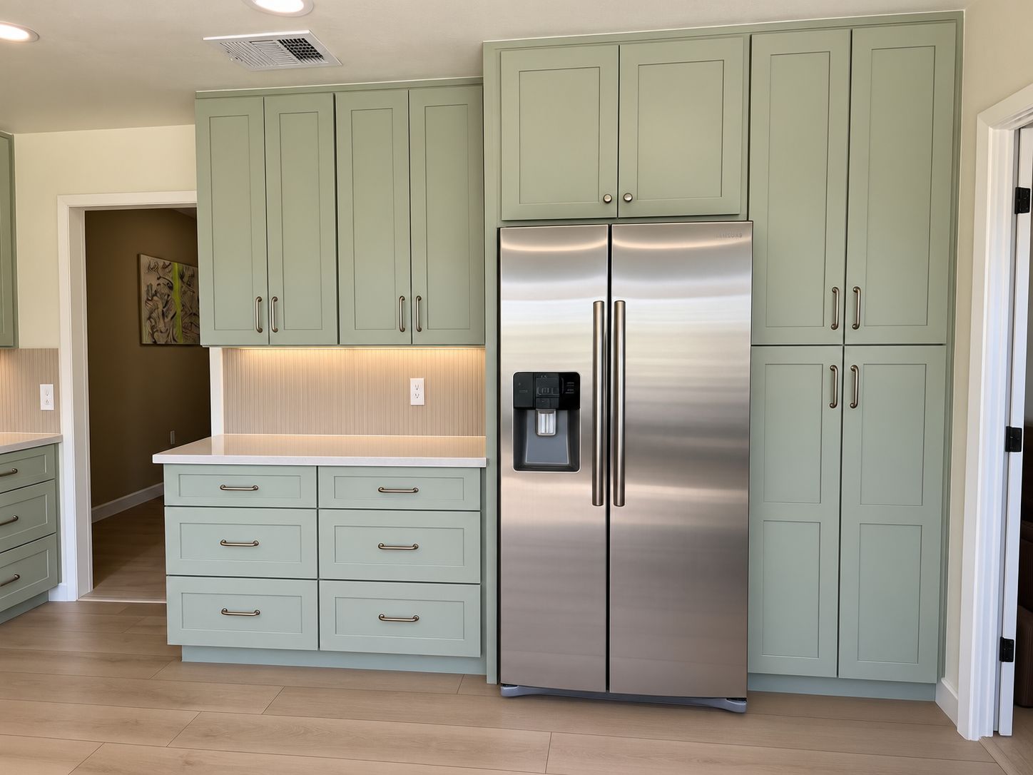 Northwest Austin kitchen remodel with Softened Green shaker cabinets extending to the ceiling and MSI quartz countertops