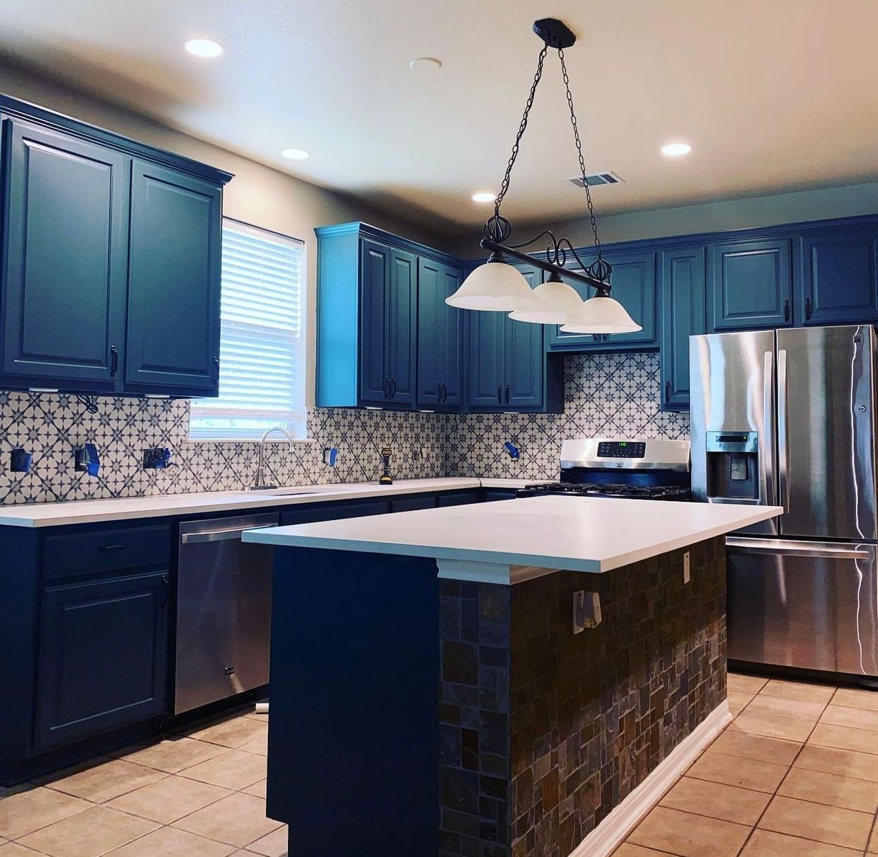 After photo of Round Rock kitchen remodel with painted cabinets quartz countertops tile backsplash