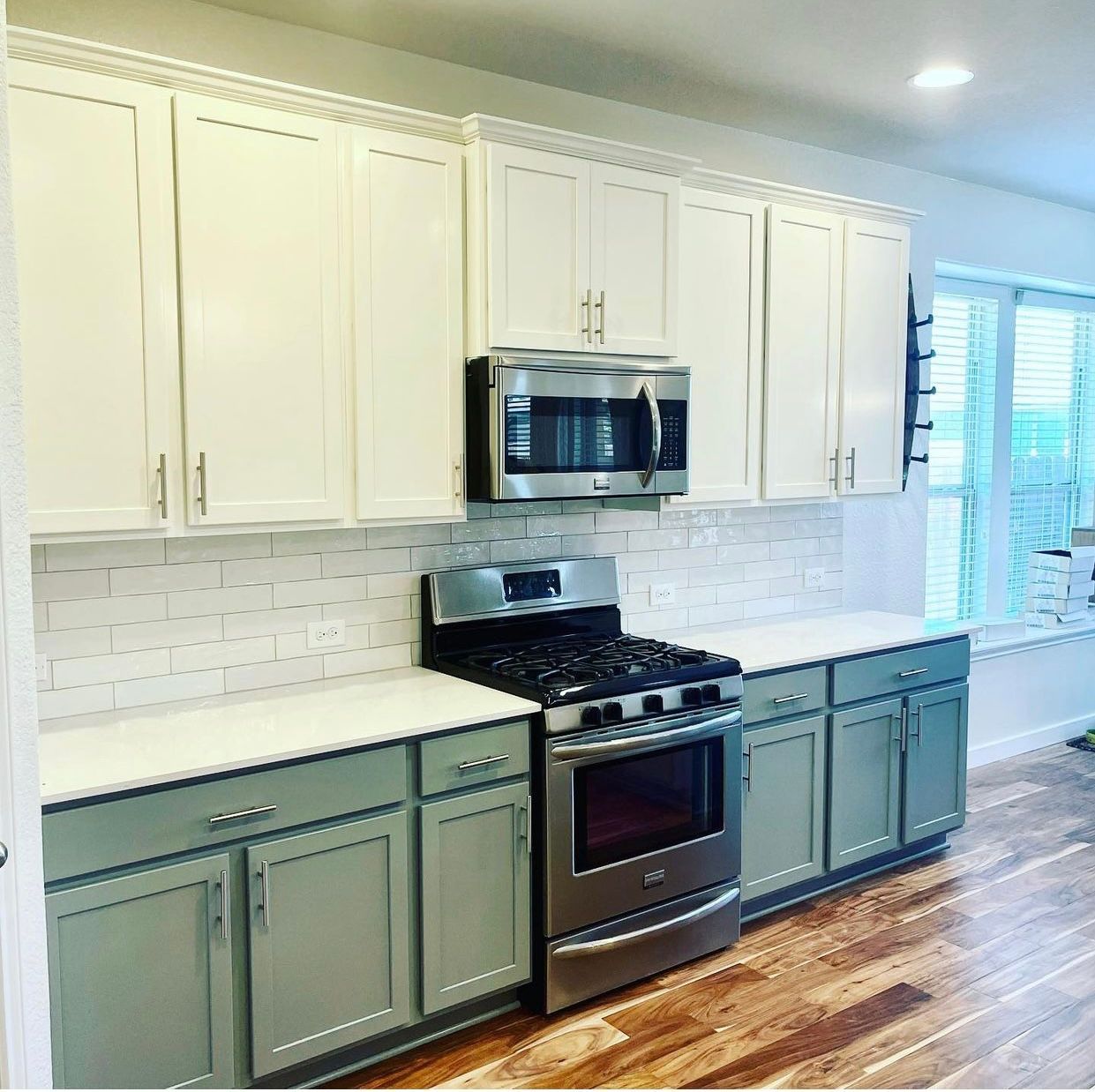 Round Rock kitchen remodel with painted cabinets quartz countertops and flooring