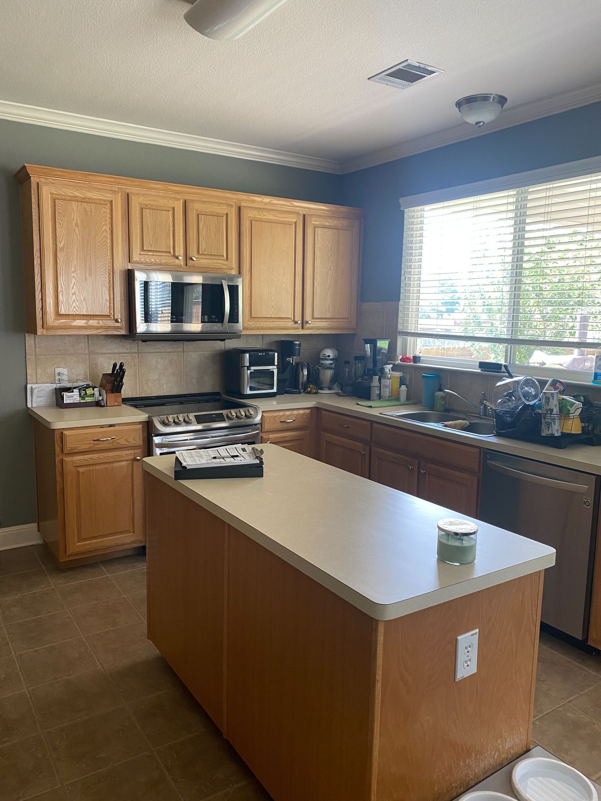 Round Rock kitchen before remodel with dated cabinet finish and countertops
