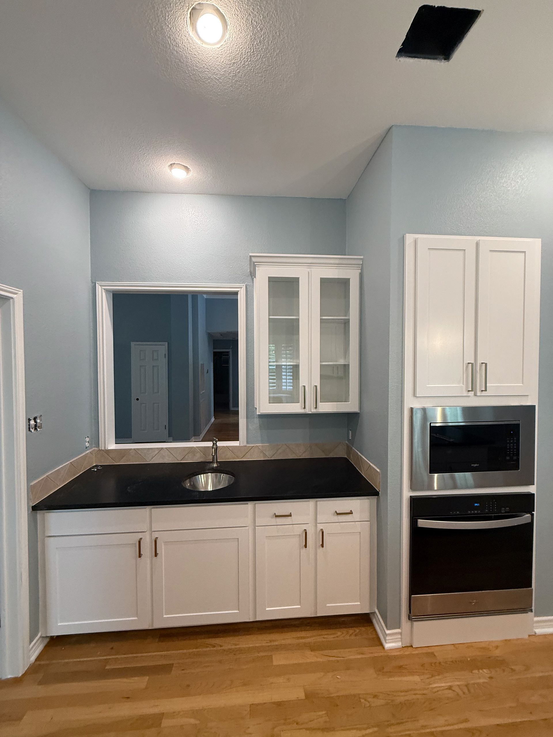 Circle C Austin cabinet refacing with new shaker doors, glass cabinet inserts, and cabinet painting