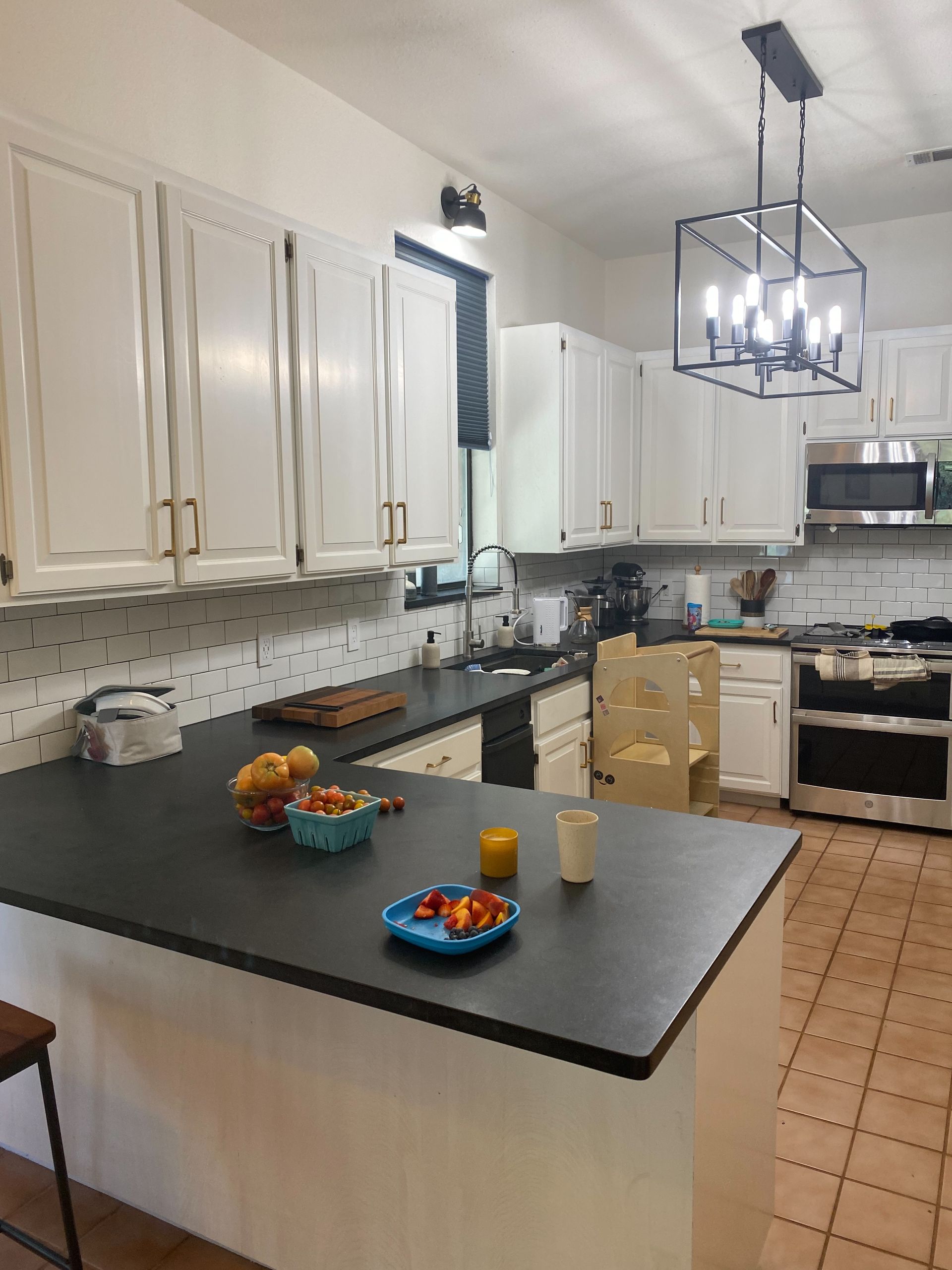 Spicewood kitchen remodel with painted cabinets quartz countertops and tile backsplash