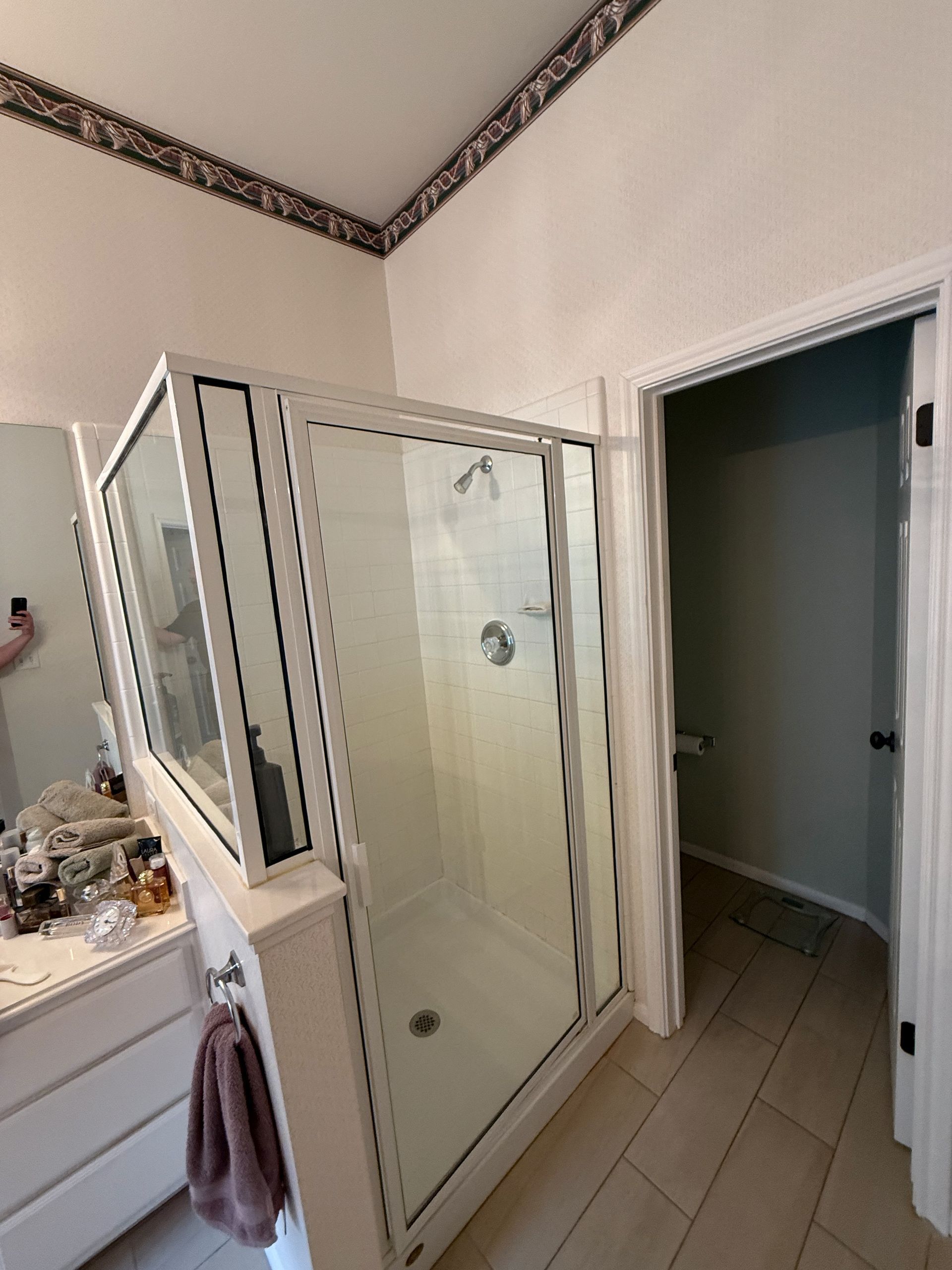 Steiner Ranch bathroom before remodel with dated finishes and wallpaper