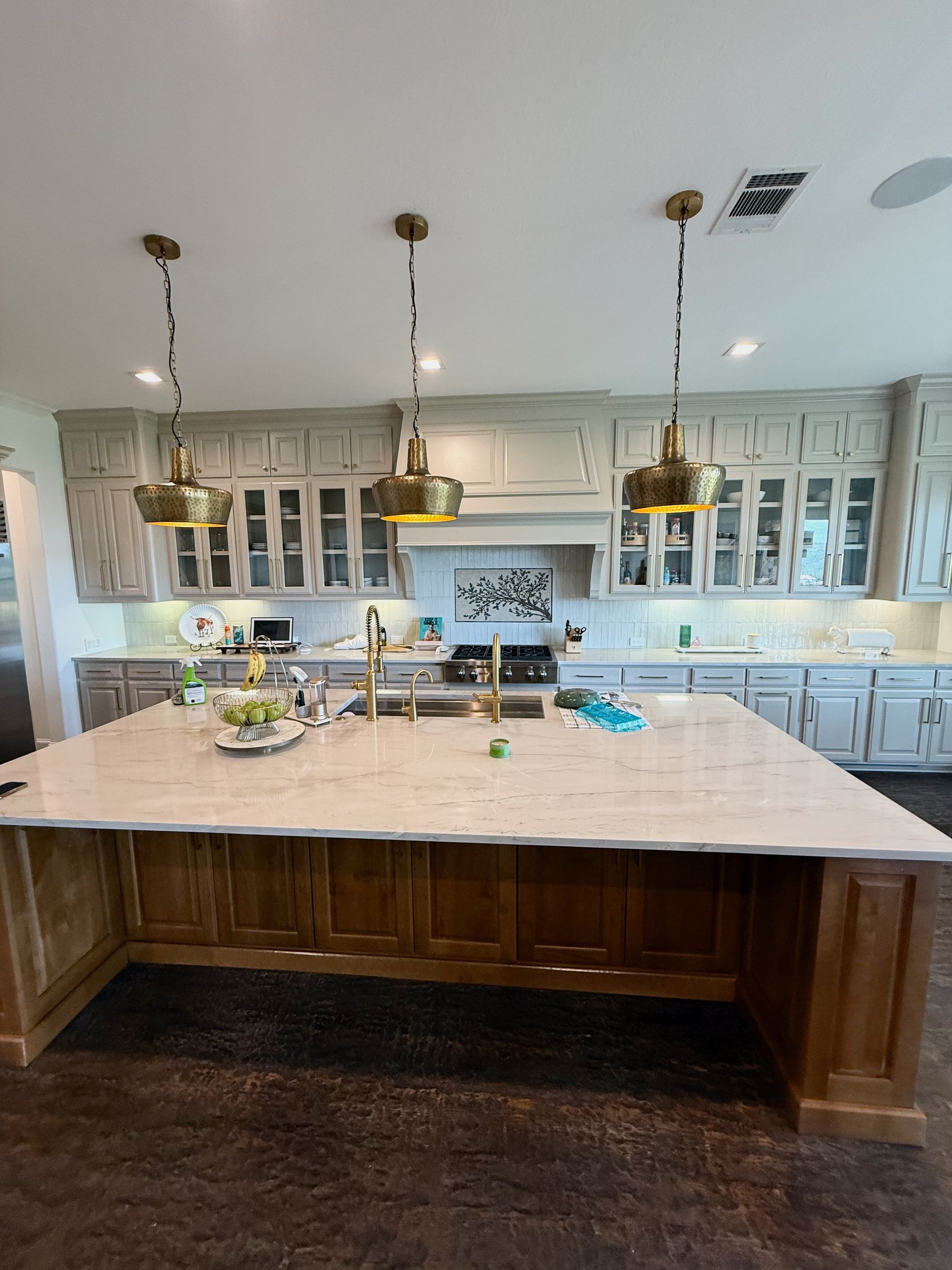 Steiner Ranch kitchen remodel with custom alder island, quartzite countertops, and painted cabinets